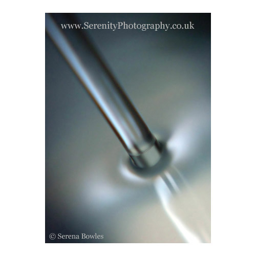 Abstract image: a trickle of water; soft substance resembling steel